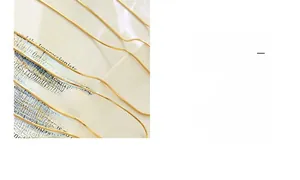 Detail of delicate 18K gold plated snake chain necklaces with polished square love pendant