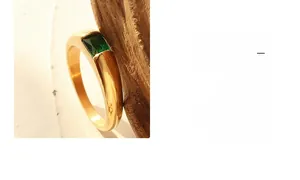 Detailed view of rectangle emerald-cut green zircon set in 18K gold plated ring band