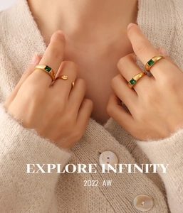 Close-up of elegant 18K gold plated ring featuring a rectangular emerald green zircon