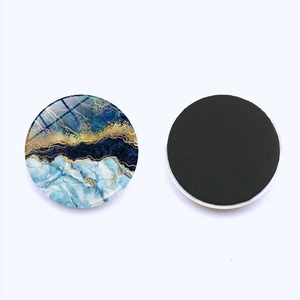 Detailweergave van ronde koelkastmagneten met blauw-gouden marmerstructuur en patronen