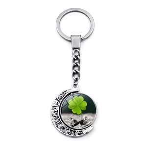 Rotating lucky green four-leaf clover pendant in silver crescent moon keychain
