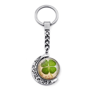 Silver crescent moon keychain with double-sided rotating four-leaf clover glass pendant