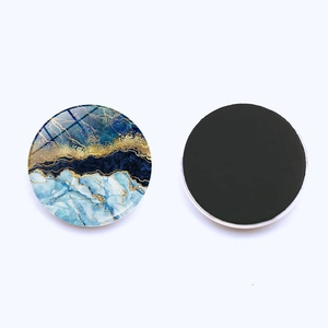 Detail of 30mm marble pattern glass fridge magnet with magnetic backing and blue gold swirls