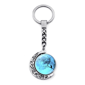 Silver crescent moon keychain with double-sided rotating blue moon and black cat on tree
