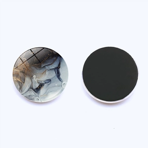 Macro detail of round 30mm marble glass fridge magnet with magnetic back for decor