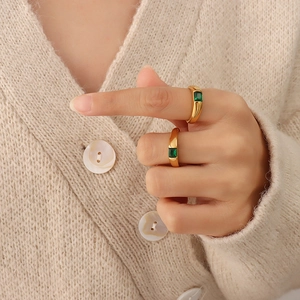 Elegant 18K gold plated titanium ring set featuring emerald green zircon stones