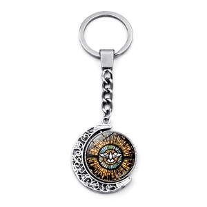 Silver crescent moon keychain with double-sided rotating stained glass dove pendant