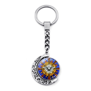 Detailed close-up of rotating double-sided moon dove pendant keychain in silver finish