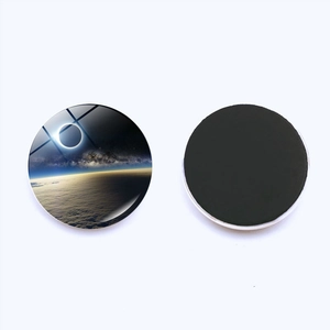 Macro view of solar eclipse glass fridge magnet with black magnetic base on white background