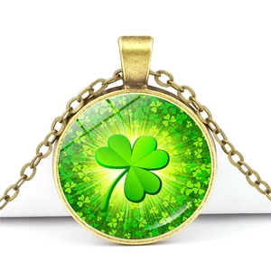 Macro shot of bronze vintage clover pendant with lucky green gemstone pattern necklace