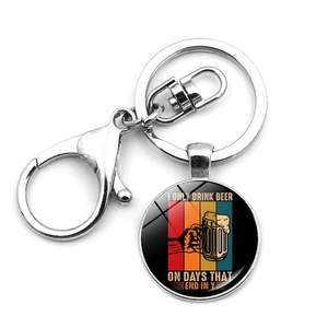 Detail of metal keychain featuring funny beer quote under glass dome for Oktoberfest