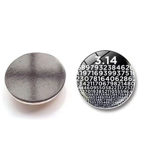 Macro detail of 30mm round glass fridge magnet with mathematical Pi constant design
