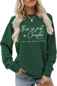 Detail of artistic white printed slogan on loose-fit dark green crewneck sweatshirt