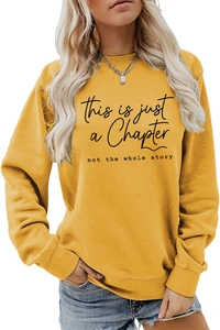 Detail of loose yellow sweatshirt with black inspirational text and round neck design