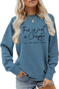 Detail of the slogan print and ribbed cuffs on the dusty blue oversized sweatshirt