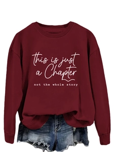 Detail of burgundy crewneck sweatshirt featuring white inspirational script lettering