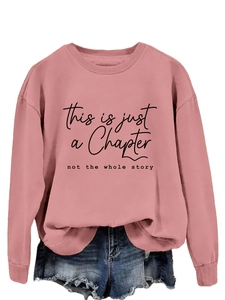 Close-up of the soft dusty pink fabric with black slogan print and ribbed neckline