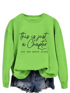 Detail of loose neon green sweatshirt with black text print and casual crew neck design