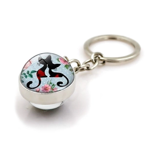 Cute black cat glass cabochon keychain with blue polka dot background on white base