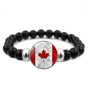 Elastic black beaded bracelet with a silver maple leaf flag charm for women