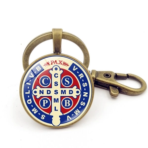 Detail of vintage Saint Benedict Medal keychain with bronze finish and glass dome