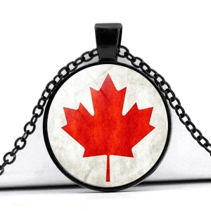 Detail of Canadian flag glass pendant with red maple leaf and black metal chain