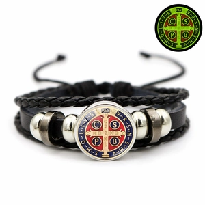 Glow-in-the-dark St Benedict medal on a triple-layer braided black leather bracelet