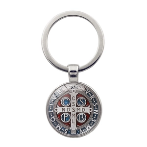 Close-up of Saint Benedict Medal keychain with red and blue enamel detail on silver metal