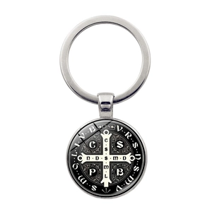 Close-up of Saint Benedict Medal keychain with silver finish and detailed religious symbols