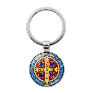 Close-up of Saint Benedict Medal keychain with red cross and colorful religious details