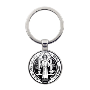 Detailed view of silver St. Benedict religious medal keychain with black and white inlay