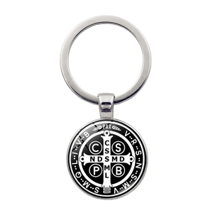 Detail of St. Benedict Medal keychain with polished silver metal ring and glass dome