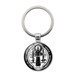 Macro detail of Saint Benedict Medal keychain with polished metal ring and clear glass dome