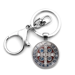 Macro detail of Saint Benedict Medal keychain with red and blue cold enamel finish