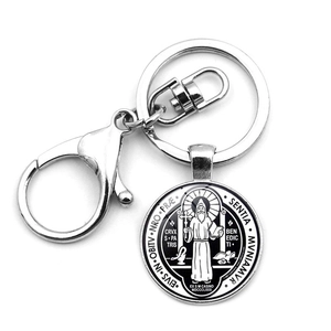 Macro detail of silver Saint Benedict Medal keychain with sturdy lobster clasp