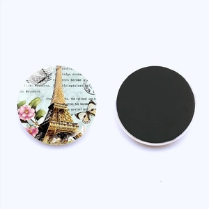 Macro shot of Paris Eiffel Tower round fridge magnets with vintage postcard design and magnetic back