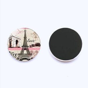 Detail of round Paris Eiffel Tower fridge magnets showing front design and magnetic back