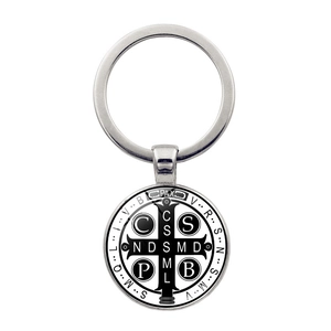 Saint Benedict Medal keychain with silver polished metal pendant on white background