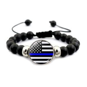 Detail of beaded bracelet with Thin Blue Line American flag charm and adjustable cord