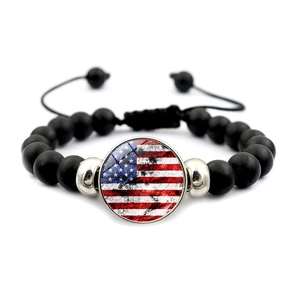 Macro detail of American flag beaded bracelet with matte black stone and adjustable cord