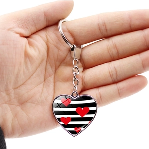 Double-sided heart keychain pendant with black and white stripes and red hearts