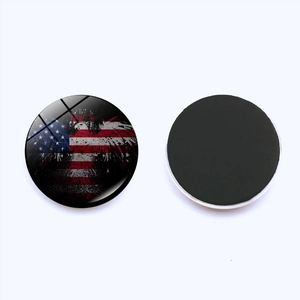 Macro shot of 25mm vintage American flag glass fridge magnets with a magnetic backing