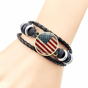 Vintage multi-layer braided leather bracelet featuring USA flag charm worn on wrist