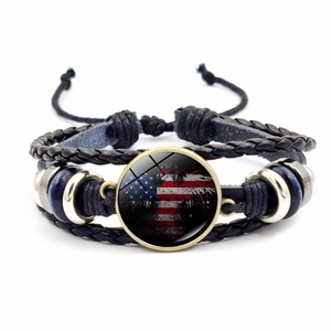 Macro shot of braided leather USA flag bracelet with glass gem and adjustable cord