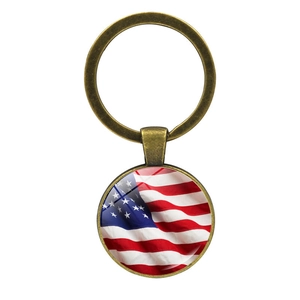 Close-up of vintage bronze American flag keychain with glass dome time gem pendant
