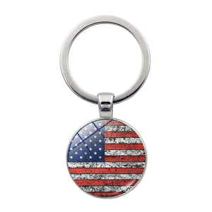 Detailed close-up of retro US flag keychain with vintage glass dome and silver metal ring