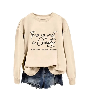 Women loose beige sweatshirt with quote print paired with frayed denim shorts