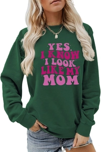 Detail view of pink lettering on dark green cotton sweatshirt with ribbed crewneck