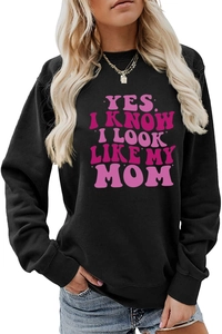 Detail of pink Yes I Know I Look Like My Mom slogan print on black long sleeve sweatshirt