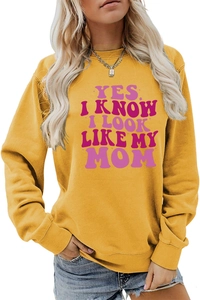 Detail of vintage purple typography print on bright yellow long-sleeved crewneck sweatshirt